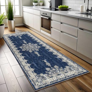 May include: A blue and white patterned runner rug with a traditional design. The rug is placed in a kitchen with hardwood floors.