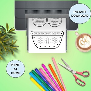 May include: Printable Easter basket coloring page with the Spanish text "Bendiciones de Pascua" and two small circles with Spanish text. The page is on a printer with colorful markers and scissors nearby.