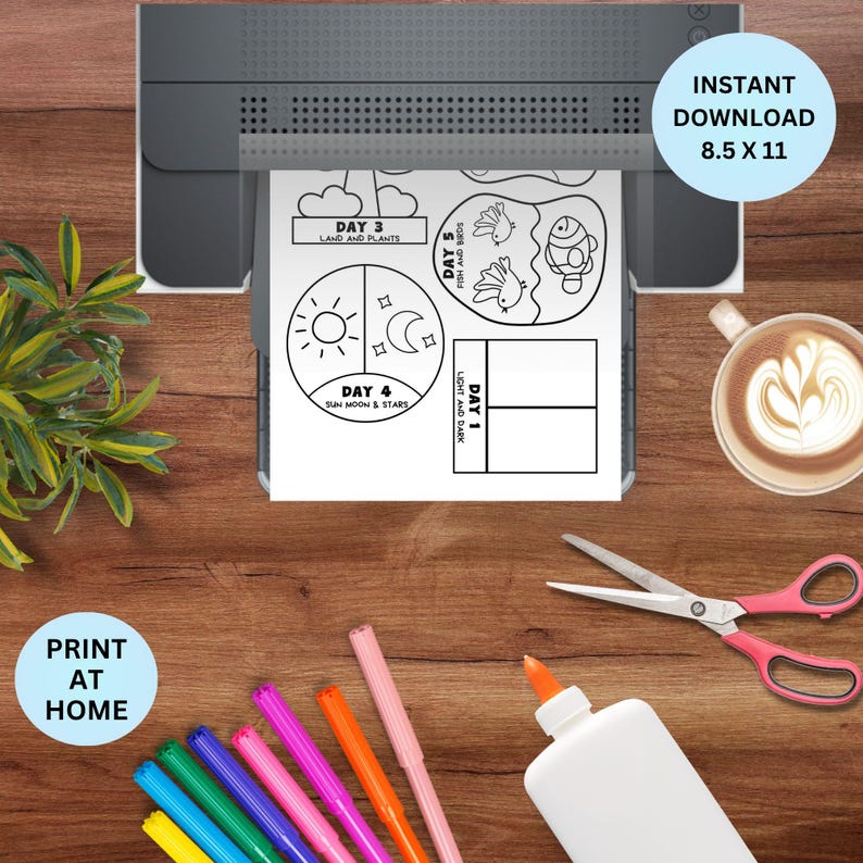 May include: A printer printing a black and white printable activity sheet. The sheet includes the text "DAY 3 LAND AND PLANTS", "DAY 4 SUN MOON & STARS", "DAY 5 FISH AND BIRDS", and "DAY 1 LIGHT AND DARK". The sheet is 8.5 x 11 inches. Colored markers, scissors, and glue are on the wooden surface.