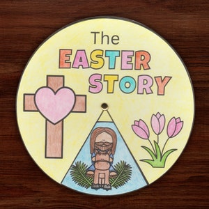 May include: A yellow circle with the words "The Easter Story" in colourful letters. The circle is divided into three sections. The first section shows a brown cross with a pink heart. The second section shows a man with a beard riding a donkey. The third section shows three pink tulips with green stems and leaves.