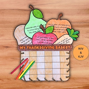 May include: A colourful Thanksgiving craft kit featuring a basket shape filled with paper cutouts of a pear, apple, pumpkin, and carrot, each with Bible verses. The words "MY THANKSGIVING BASKET" are printed on the basket. Includes crayons.