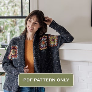 May include: A crochet cardigan with a granny square pattern in shades of gray, orange, yellow, green, and purple. The cardigan has a shawl collar and long sleeves. The text "PDF PATTERN ONLY" is displayed on a green rectangle.
