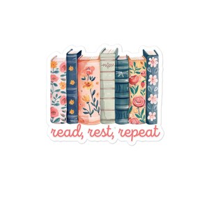 May include: A sticker showing a collection of seven books with floral patterns and the text "read, rest, repeat". The books are in various colours, including pink, blue, orange, and green, with flower and leaf designs.