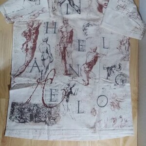 May include: A white t-shirt with a print of anatomical drawings and the word "HEILANGELO" in a stylized font.