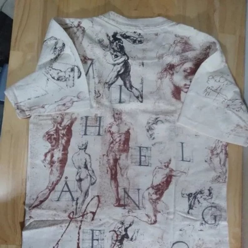 May include: White t-shirt with a print of various anatomical drawings and the letters "HEALING" in a large font.