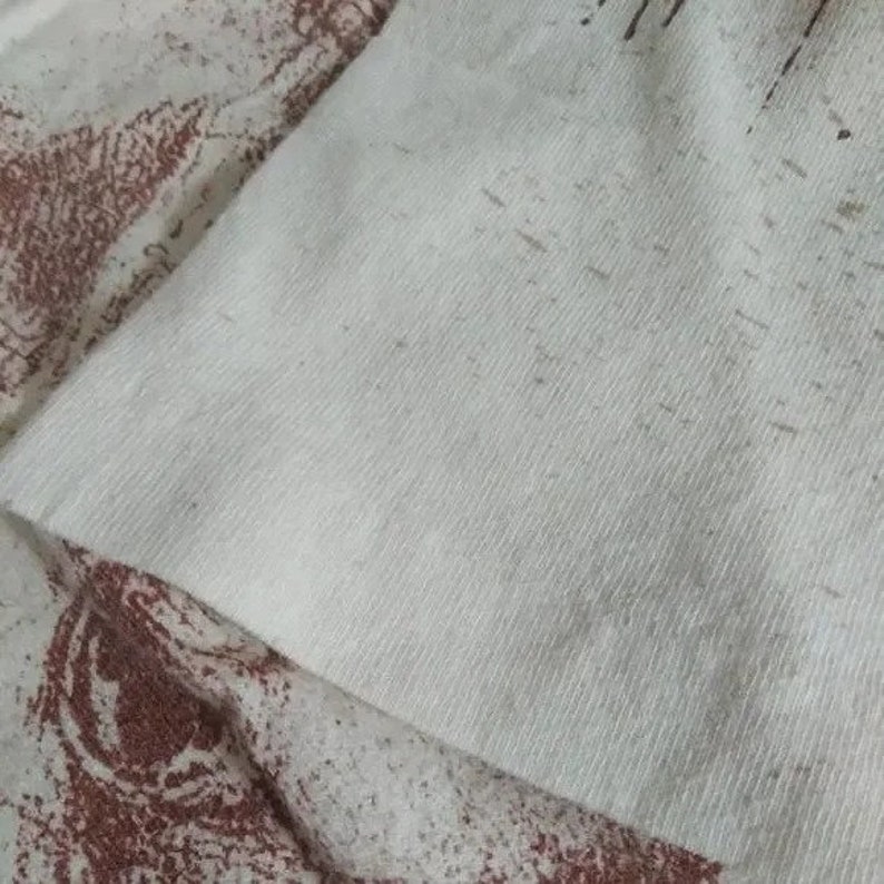 May include: Close-up of a white cotton fabric with a fine weave. The fabric has a slightly textured surface and appears to be very soft.