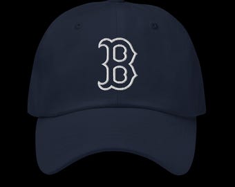May include: A navy blue baseball cap with a white embroidered "B" on the front.