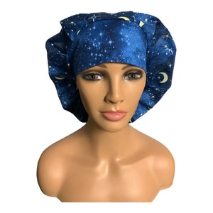 May include: Blue surgical scrub hat with a galaxy print featuring stars and moons.