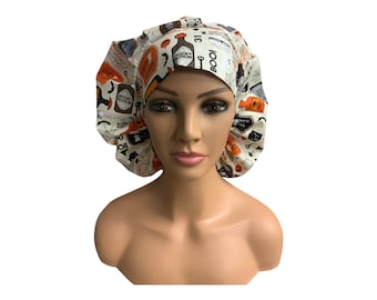 May include: A white scrub cap with a Halloween-themed print featuring orange, black, and white illustrations of potion bottles, bats, and the words "Spooky Potion" and "Boo!"