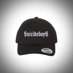 May include: Black baseball cap with white embroidered text that reads "Suicideboys$".