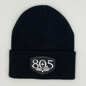 May include: Black knit beanie with a black and white embroidered patch that says "805" with a star in the center.