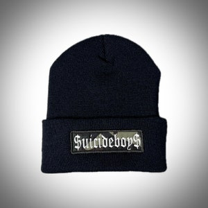 May include: Black beanie with a camouflage patch that says "Suicideboys$" in white lettering.