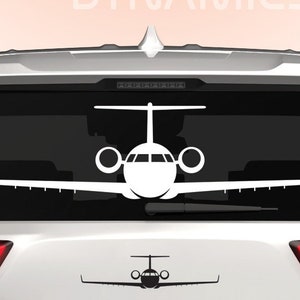 May include: White silhouette of a private jet on the back window of a white SUV. The words "DINGO DYNAMICS" are at the top of the image and the word "DINGO" is at the bottom of the image.