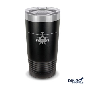 May include: A black stainless steel tumbler with a silver lid and a gray silhouette of a helicopter on the front. The tumbler has a textured, ribbed design around the bottom.