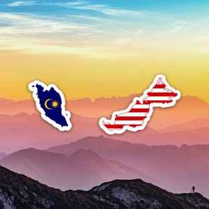 May include: Two stickers in the shape of Malaysia, one with the flag's crescent moon and star on a blue background, the other with red and white stripes. The stickers are set against a scenic mountain backdrop.