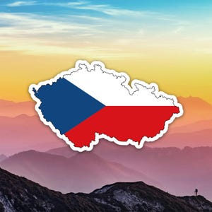 May include: A sticker in the shape of the Czech Republic, featuring the Czech flag design. The flag has a blue triangle, white, and red sections. The sticker is set against a backdrop of mountains and a colourful sky.