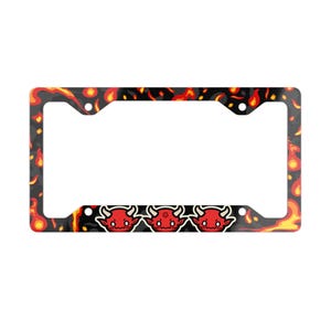 May include: Black license plate frame with a fiery design. The frame features a pattern of flames in red, orange, and yellow against a black background. Three cartoon devil faces are at the bottom.