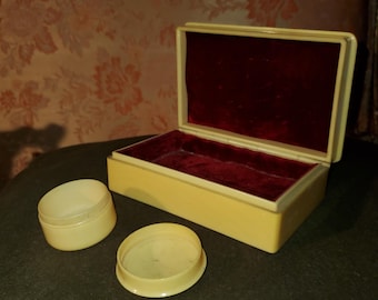 Bakelite celluloid jewelry box and round trinket box.