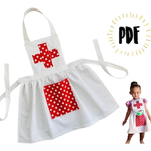 May include: White apron with red polka dots and a red cross with white polka dots. The apron has adjustable straps and a pocket. The apron is for pretend play and is perfect for a doctor or nurse costume.