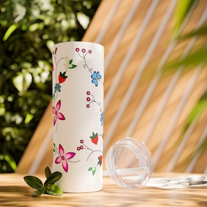 May include: White stainless steel tumbler with a floral design featuring pink, red, blue, and green flowers and berries. The tumbler has a clear lid with a straw.
