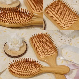 May include: Wooden hairbrushes with light brown bristles and handles. The brushes have a rectangular and oval shape. The bristles are evenly spaced and appear to be made of wood. The handles are smooth and curved for easy grip.