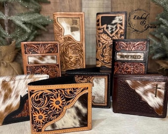 May include: A collection of leather wallets and checkbook covers featuring intricate floral tooling, hair-on-hide accents, and personalized details like the name RUBIO and initials JB. Some items display a cross emblem and basketweave patterns.
