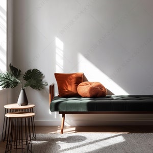 May include: A green velvet bench with wooden legs and two orange throw pillows. The bench is in a room with a window and a side table with a vase and a plant.
