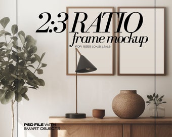 May include: A mockup featuring two framed prints with a 2:3 ratio, displayed on a wooden cabinet. A black desk lamp and decorative vase are also present. The text reads "2:3 RATIO frame mockup FOR SIZES 25x38cm, 30x46cm" and "PSD FILE WITH SMART OBJECTS."