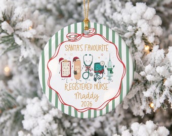May include: A round ceramic Christmas ornament with a green and white striped background. It features cartoon medical items including a clipboard, bandage, stethoscope, blood pressure cuff, and syringe. Text reads: SANTA'S FAVOURITE REGISTERED NURSE Maddy 2026.