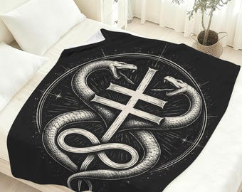 May include: Black blanket featuring a detailed graphic of two snakes coiled around a double-barred cross. The snakes are depicted in a detailed, grayscale style, set against a dark background. The design is enclosed within a circular frame.
