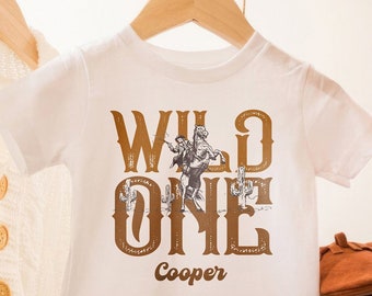 Cowboy First Birthday Shirt Custom Name • Western “Wild One” Kids Tee