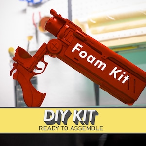 May include: A red foam kit gun with the text "Foam Kit" in white. The image also includes a yellow banner with the text "DIY KIT READY TO ASSEMBLE".