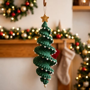 May include: A spiral-shaped crochet Christmas tree ornament in dark green yarn, featuring small white bead accents along the edges and a gold-colored crocheted star at the top. The ornament hangs from a thin string loop for display purposes.