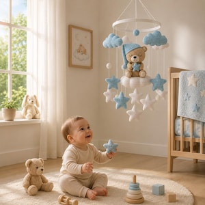 May include: A nursery mobile featuring a crocheted tan bear wearing a blue nightcap and holding a blue star, suspended from a white ring. The mobile includes several white and blue crocheted clouds and stars hanging at various levels on white strings.