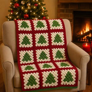 May include: A crochet blanket featuring a repeating pattern of square blocks, each containing a green Christmas tree motif centered within an off-white border. The squares are joined together by a deep red yarn, creating a grid-like structure.