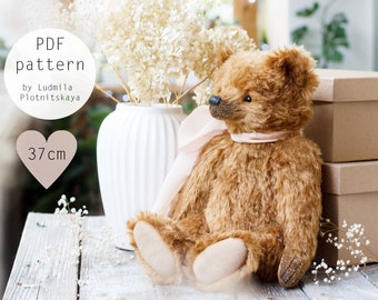 May include: PDF pattern for a 37-inch teddy bear with brown fur and a pink ribbon. The pattern is by Ludmila Plotnitskaya.