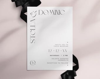 May include: A white wedding invitation with black text and a black ribbon. The invitation reads "Stella & Dominic" and includes the wedding date, time, and location. The invitation is on a light pink background.
