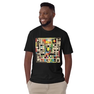 May include: A black t-shirt featuring a colourful graphic of a colour chart with a circle in the centre. The chart has squares of different colours, including red, yellow, blue, green, and black.