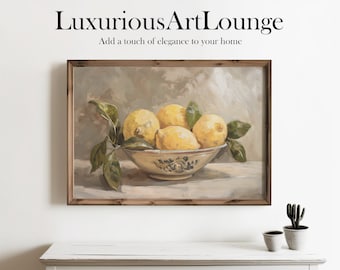 May include: A painting of a bowl of lemons with green leaves. The bowl is white with blue and white floral designs. The painting is framed in a light brown wood frame.