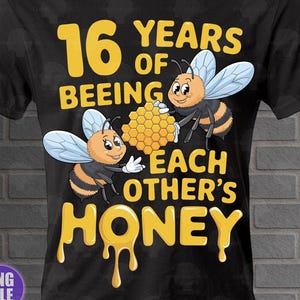 May include: Black t-shirt with a yellow graphic that reads "16 YEARS OF BEEING EACH OTHER'S HONEY." The design features two cartoon bees holding a honeycomb. The shirt is made of a soft material.