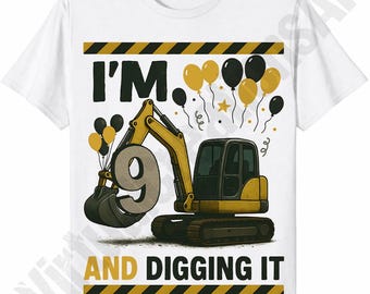 May include: White t-shirt with a colorful graphic. The design features a yellow and black excavator holding a large number 9, with the text "I'M 9 AND DIGGING IT". Balloons and a star complete the birthday theme.