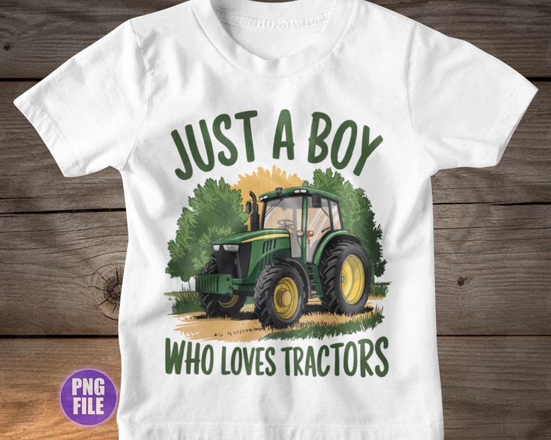May include: White t-shirt featuring a green tractor graphic with yellow wheels. The text "JUST A BOY WHO LOVES TRACTORS" is printed above and below the tractor illustration in green. The shirt is made of a soft material.