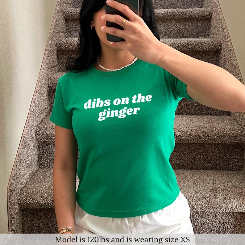 May include: A green t-shirt with white text that reads "dibs on the ginger".
