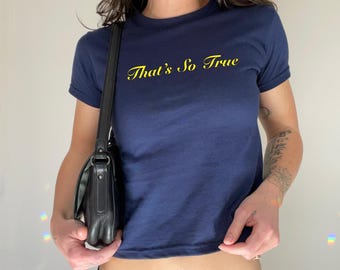 May include: A navy blue cropped t-shirt with the text "That's So True" in yellow lettering.