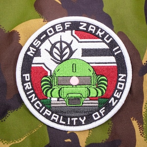 May include: A white, black and red embroidered patch with the text "MS-06F ZAKU II PRINCIPALITY OF ZEON" and a green and black illustration of a robot head.