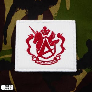 May include: White embroidered patch with a red crest featuring a unicorn, a crown, a winged hand, and a ribbon with the text "LOND-BELLT-ARMOUR".