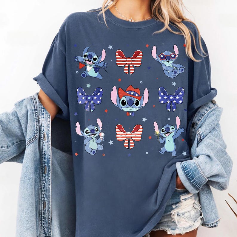 May include: A navy blue t-shirt with cartoon Stitch characters in patriotic poses. Stitch is shown with fireworks, ice cream, and wearing a cowboy hat. Red, white, and blue bows and stars are also printed on the shirt.