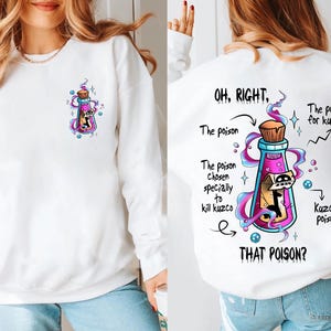 May include: White sweatshirt with a cartoon image of a potion bottle with a skull inside. The text on the back of the shirt reads "OH, RIGHT. The poison chosen specially to kill Kuzco. THAT POISON?" with a cartoon image of a potion bottle and text "The poison for Kuzco" and "Kuzco's poison".