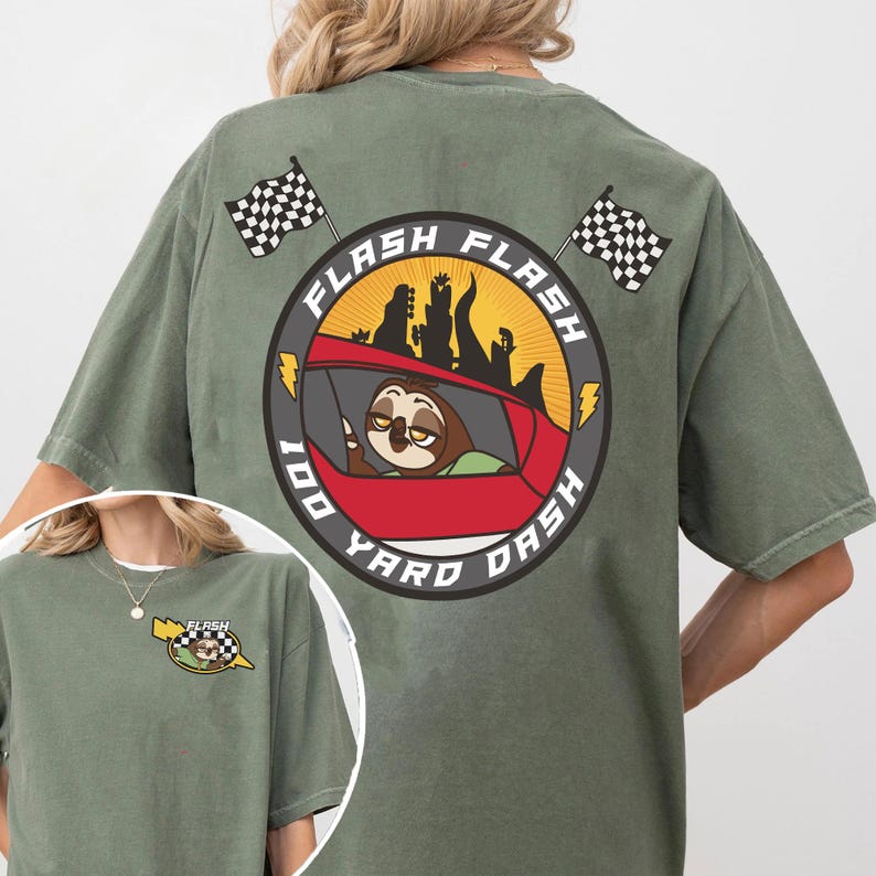 May include: Olive green t-shirt featuring a cartoon sloth driving a red car with the text "Flash 100 Yard Dash" in a circular design. Two checkered flags are on the top of the shirt. A smaller version of the design is on the front.
