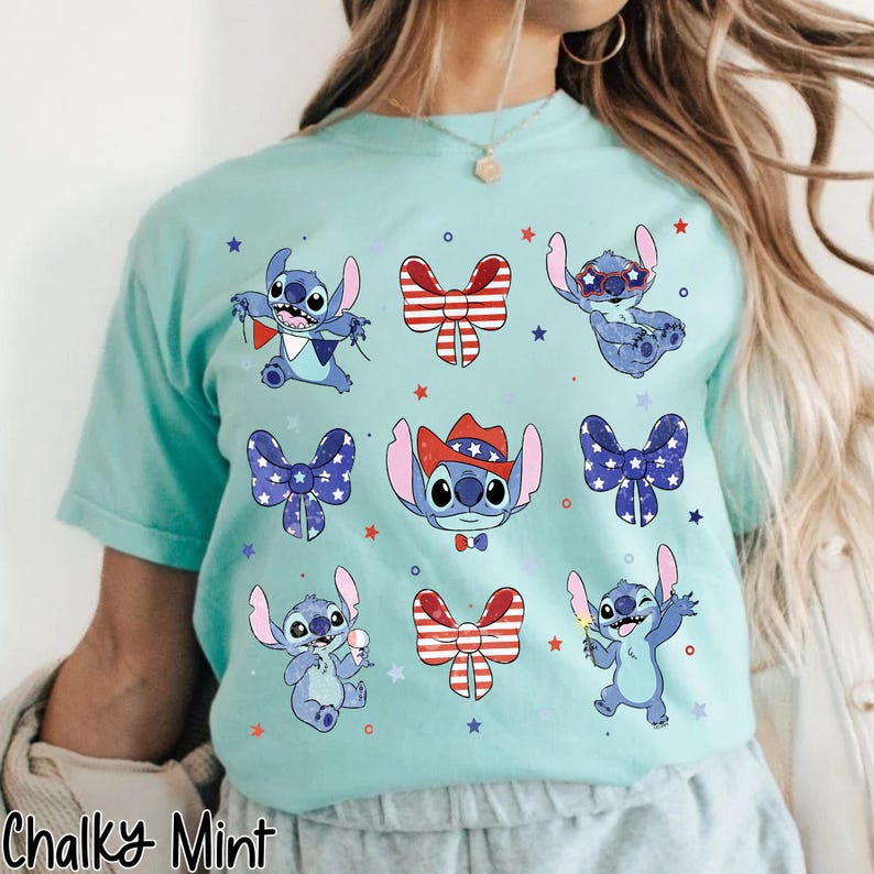 May include: A pale turquoise t-shirt with cartoon Stitch illustrations and patriotic bow tie designs. The shirt includes the text "Chalky Mint" at the bottom. The Stitch characters are surrounded by star shapes.